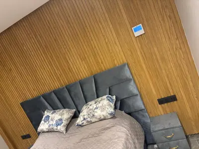 a bed with a black head board and two pillows at Elite garden in Marrakech