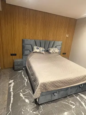 a bedroom with a large bed with two pillows on it at Elite garden in Marrakech