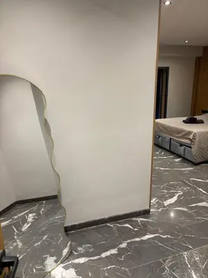 a mirror on a wall in a room with a bed at Elite garden in Marrakech