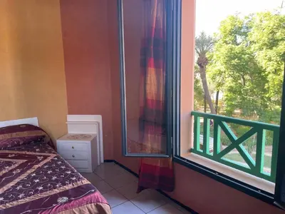 a bedroom with a bed and a window with a view at Majorele in Marrakech