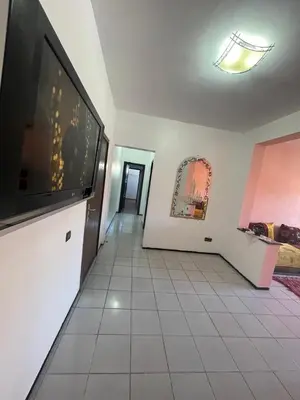 a living room with a large flat screen tv on a wall at Majorele in Marrakech