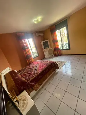 a bedroom with a bed in a room with windows at Majorele in Marrakech