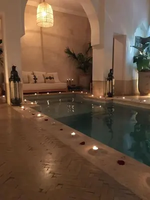 a swimming pool with lights in a living room at Oasis de la Médina -Piscine Chauffée - Climatisation Petit-Déjeuner et Gouvernante in Marrakech