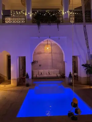 a swimming pool with blue lighting in a house at Oasis de la Médina -Piscine Chauffée - Climatisation Petit-Déjeuner et Gouvernante in Marrakech