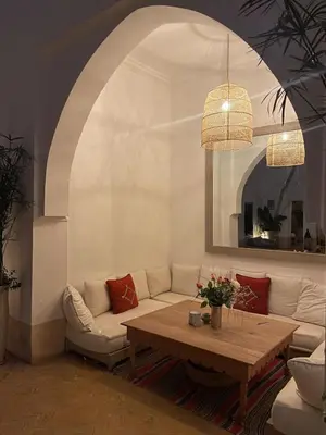 a living room with a couch and a table at Oasis de la Médina -Piscine Chauffée - Climatisation Petit-Déjeuner et Gouvernante in Marrakech