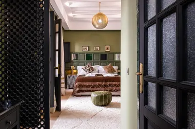 a bedroom with a bed and a room with a door at Riad Layl Marrakech a seulement 2 minutes à pied de la célèbre place Jemaa El Fna in Marrakech