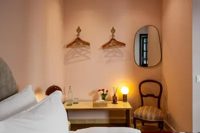 a bedroom with a table and a mirror and a bed at Riad Layl Marrakech a seulement 2 minutes à pied de la célèbre place Jemaa El Fna in Marrakech