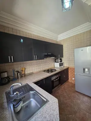 a kitchen with a sink and a refrigerator at andlous 4 in Marrakech