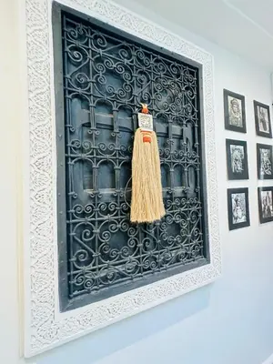 a black and white picture with a broom on a wall at Riad Bayas - Comfort & Authenticity in Marrakech