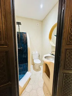a bathroom with a toilet and a shower and a sink at Riad Bayas - Comfort & Authenticity in Marrakech