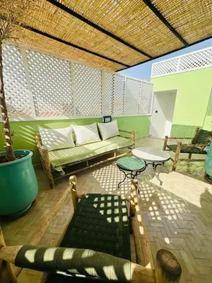 a living room with a couch and a table at Riad Bayas - Comfort & Authenticity in Marrakech