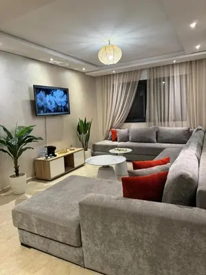 a living room with a couch and a table at appartement vue piscine enjoy & relax in Marrakech