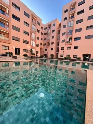 a swimming pool in front of two large buildings at appartement vue piscine enjoy & relax in Marrakech