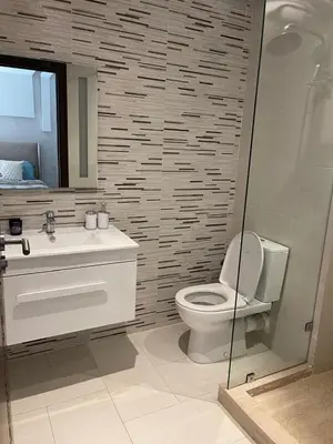 a bathroom with a toilet and a sink and a mirror at appartement vue piscine enjoy & relax in Marrakech