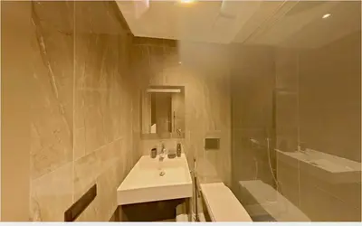 a bathroom with a sink and a toilet and a shower at Appartement chic Menara Mall piscine Rooftop in Marrakech
