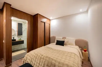 a bedroom with a large bed and a bathroom at NEW !!! Organic design apartment-Center Marrakech getaway in Marrakech