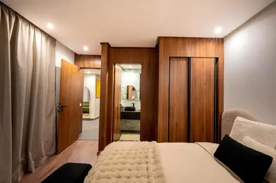 a bedroom with a bed and a door to a bathroom at NEW !!! Organic design apartment-Center Marrakech getaway in Marrakech