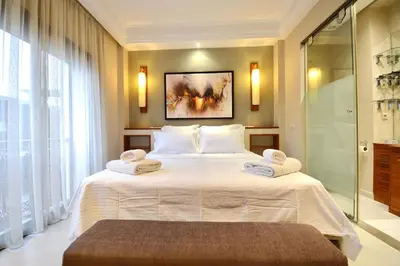 a bedroom with a large bed with towels on it at 1 King BR with AC, Roof Pool & View-Perfect for 2- City Center in Marrakech