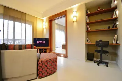 a living room with a couch and a chair at 1 King BR with AC, Roof Pool & View-Perfect for 2- City Center in Marrakech
