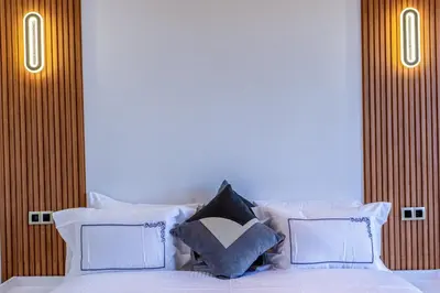 a bedroom with a white bed with white pillows at Villa Santa Marrakech in Marrakech