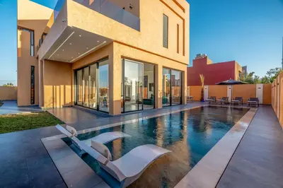 a swimming pool in the middle of a house at Villa Santa Marrakech in Marrakech