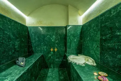 a green bathroom with green walls and green tiles at Villa Santa Marrakech in Marrakech