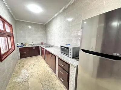 a kitchen with a refrigerator and a microwave at Spacious Villa with Private Pool in Oulad Lahsene