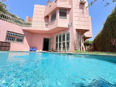 a building with a swimming pool in front of it at Spacious Villa with Private Pool in Oulad Lahsene