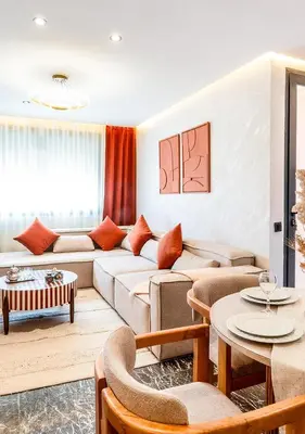 a living room with a couch and tables at Terracotta Stay - Free parking in Marrakech