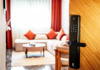 a remote control sticking out of a door in a living room at Terracotta Stay - Free parking in Marrakech
