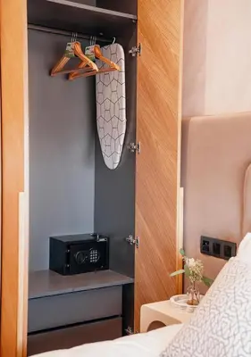 a bedroom with a bed and a door with a microwave at Terracotta Stay - Free parking in Marrakech