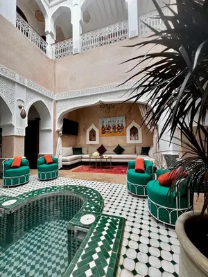 a living room with a pool in a building at riad les cinq terres in Marrakech