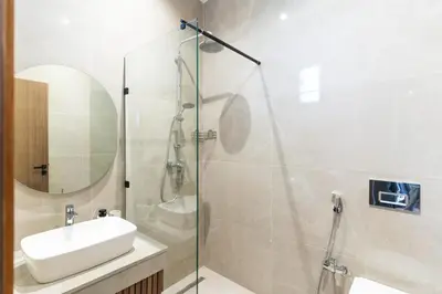 a bathroom with a shower and a sink and a shower at Luxury Villa with Heated Pool & Private cinema in Marrakech