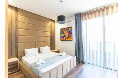 a bedroom with a large bed and a large window at Luxury Villa with Heated Pool & Private cinema in Marrakech
