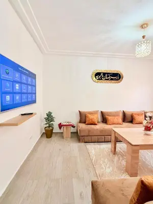 a living room with a couch and a table at A24 Confortable Moderne Au Centre-ville in Marrakech