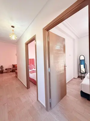 a room with a door leading to a bedroom at A24 Confortable Moderne Au Centre-ville in Marrakech