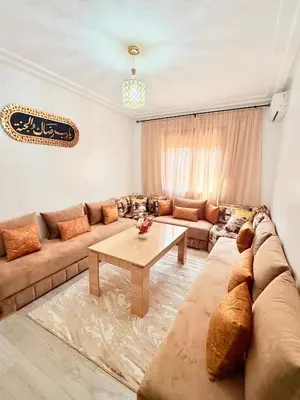 a living room with a couch and a table at A24 Confortable Moderne Au Centre-ville in Marrakech