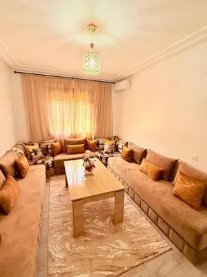 a living room with a couch and a table at A24 Confortable Moderne Au Centre-ville in Marrakech