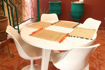 a white table with white chairs and a white table with at Central terrace XXL - Carré Eden - smart Lock in Marrakech