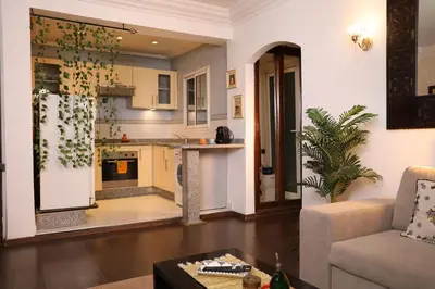 a living room with a couch and a kitchen at Central terrace XXL - Carré Eden - smart Lock in Marrakech