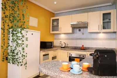 a kitchen with a white refrigerator and a counter at Central terrace XXL - Carré Eden - smart Lock in Marrakech