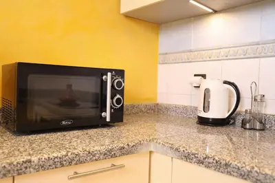a microwave sitting on a counter in a kitchen at Central terrace XXL - Carré Eden - smart Lock in Marrakech
