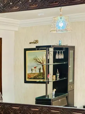 a room with a shelf with a painting and a chandelier at Central terrace XXL - Carré Eden - smart Lock in Marrakech