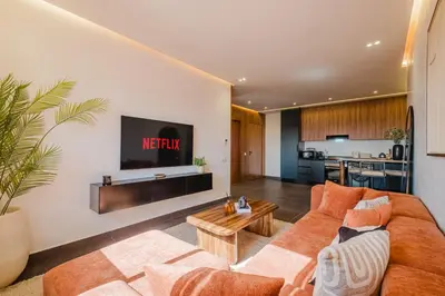a living room with a couch and a tv at Sejour lumineux et moderne dans le centre de Marrakech in Marrakech