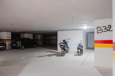 a parking garage with two motorcycles parked in it at Sejour lumineux et moderne dans le centre de Marrakech in Marrakech
