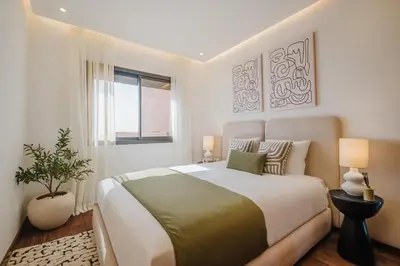a bedroom with a large bed and a window at Sejour lumineux et moderne dans le centre de Marrakech in Marrakech