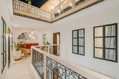 a staircase in a home with black windows at Riad Imrani - piscine - 6 mn from Jamaa Al Fna in Marrakech