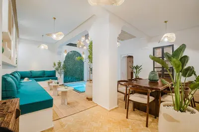 a living room with a blue couch and a table at Riad Imrani - piscine - 6 mn from Jamaa Al Fna in Marrakech