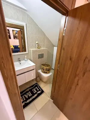 a bathroom with a sink and a toilet and a mirror at Duplex chic et lumineux avec piscine proche centre in Marrakech