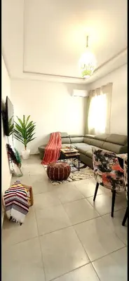 a living room with a couch and a table at Appartement a 5 min de l aeroport de marrakech in Marrakech